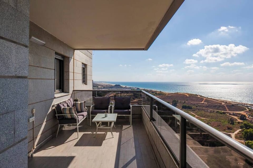 Long balcony offers outdoor seating and dining, perfect for enjoying sunsets near beach and shops.