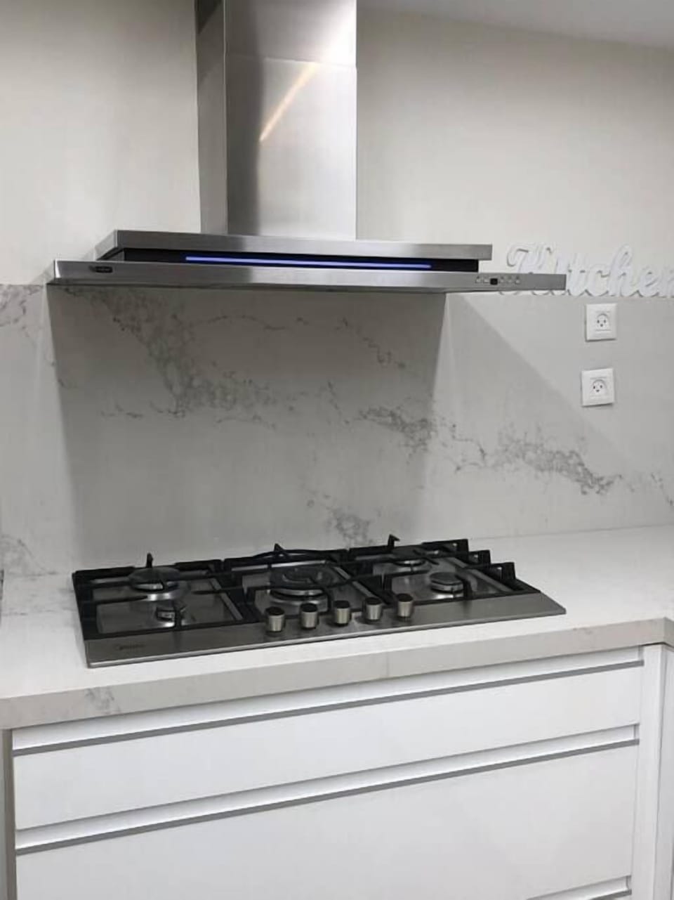 Gas cooktop and sleek finishes provide cooking space, supported by responsive hosts during your stay.