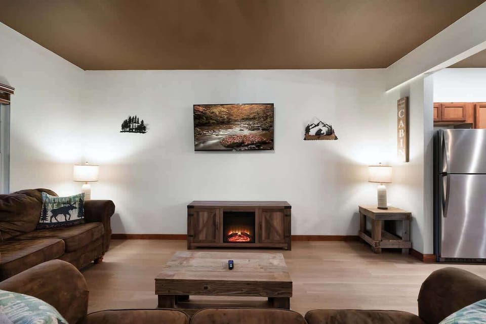 Unwind by the warming glow of the electric fireplace in this rustic retreat!