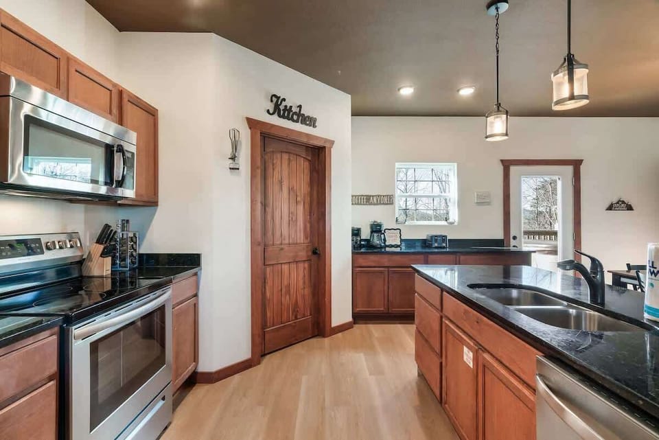 Expansive counters and modern appliances await your culinary creations! Enjoy scenic views!