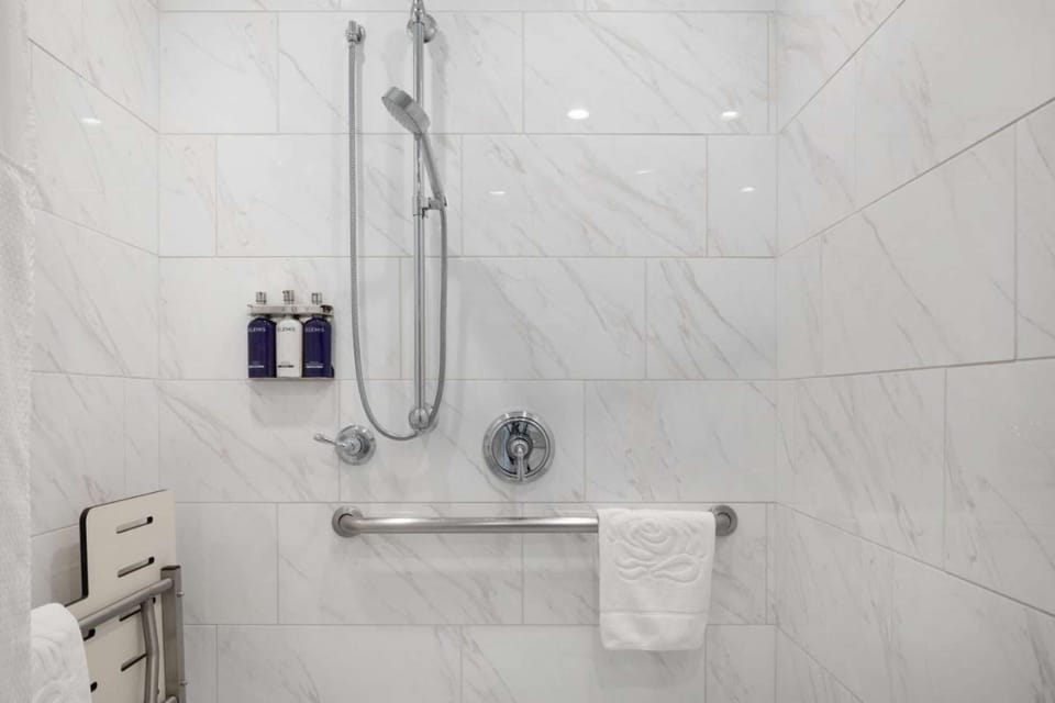 The bathrooms come with rails, toiletries, and a shower.