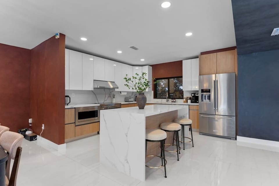 Enjoy a fully equipped kitchen with quartz countertops, large island seating, and everything you need for the perfect stay.