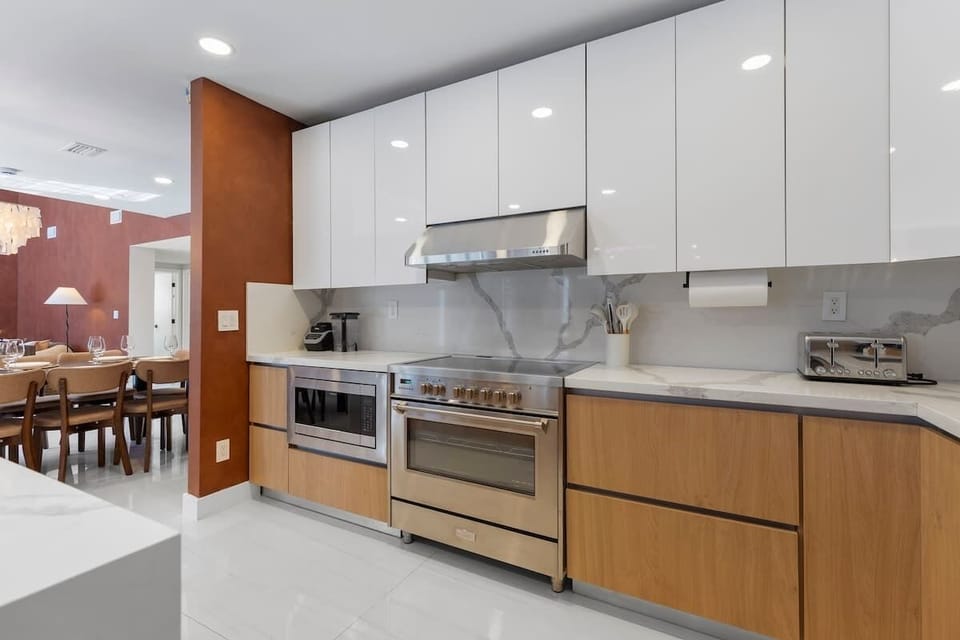 High-end appliances, streamlined cabinetry, and thoughtful touches make cooking effortless.