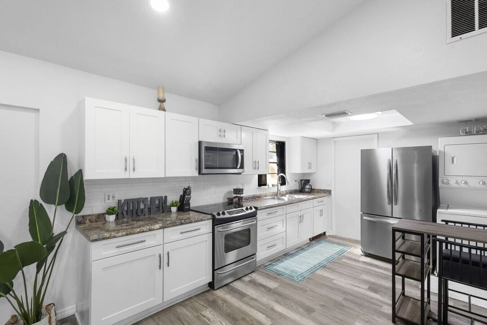 Bright and spacious kitchen with full-size fridge, stove, and microwave