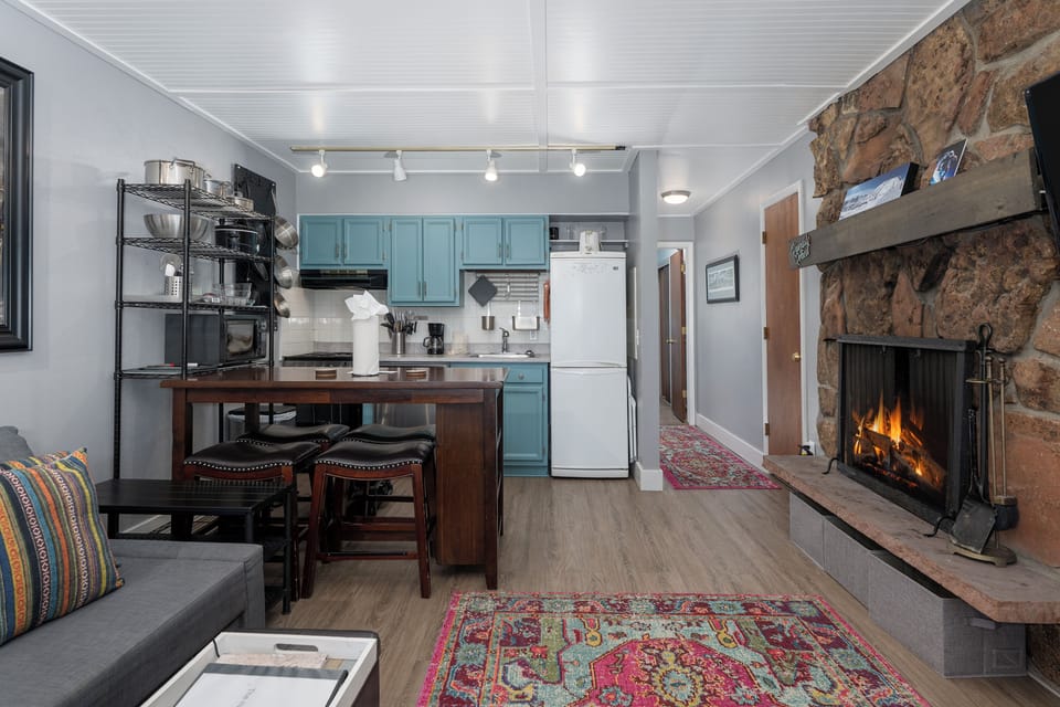 Your open-concept space combines kitchen, dining and living areas with a crackling stone fireplace as your cozy centerpiece.