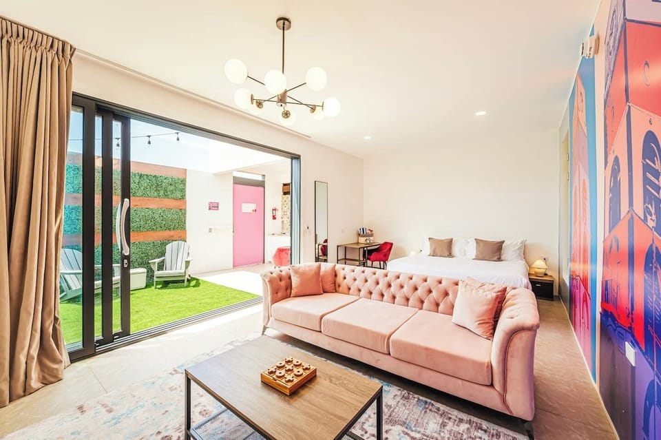 XL sofa, king-size bed, and simple workspace keep the room open and modern.