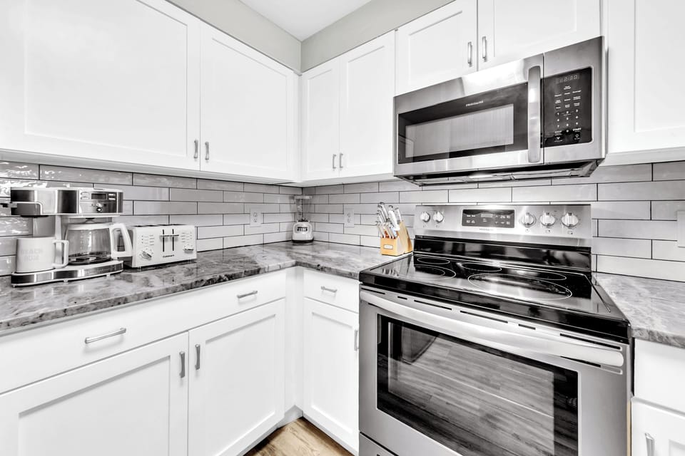 Your modern kitchen features granite countertops, stainless steel appliances, and everything needed for preparing meals during your stay.