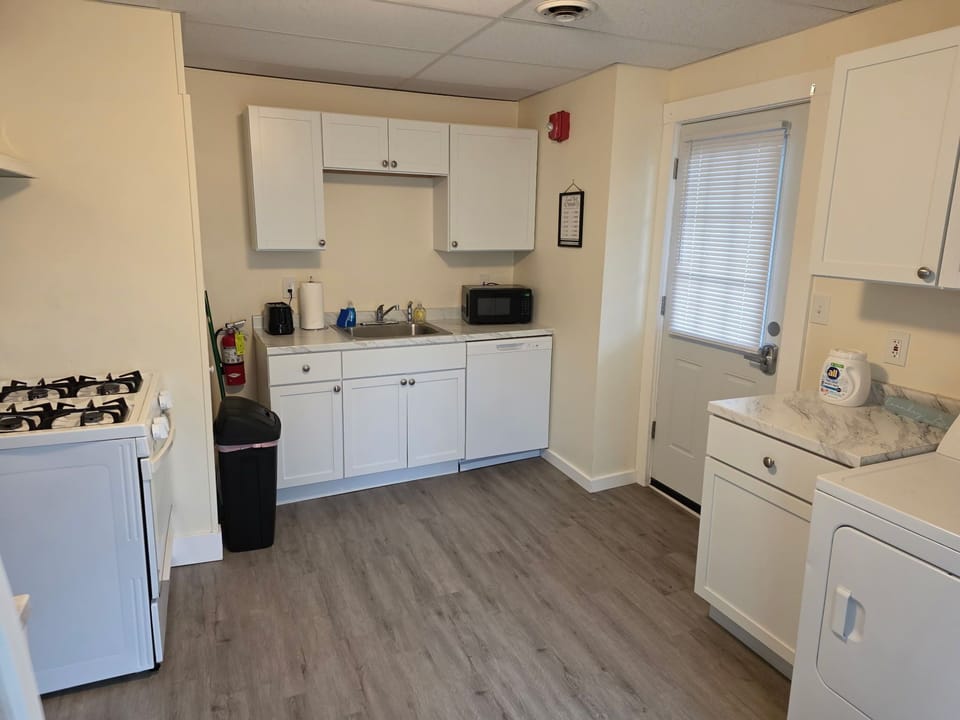 Kitchen with dishwasher and door to covered back porch