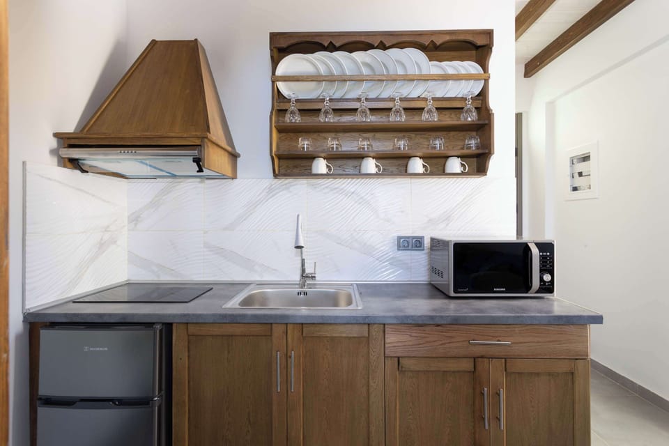 Modern Kitchenette with Window Lighting and Open Wooden Shelving
Bright, functional kitchen equipped with essentials and accented with open shelving for easy access to cookware.