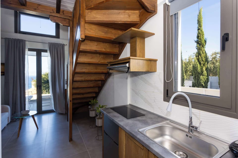 Kitchenette with Window and Open Shelving
Compact yet functional cooking area with modern appliances.