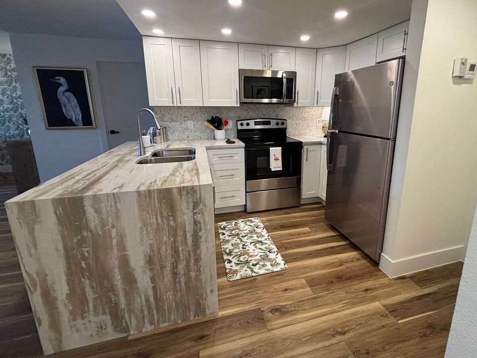 Your fully equipped kitchen features stainless steel appliances, marble countertops, and everything you need to create memorable meals during your stay.