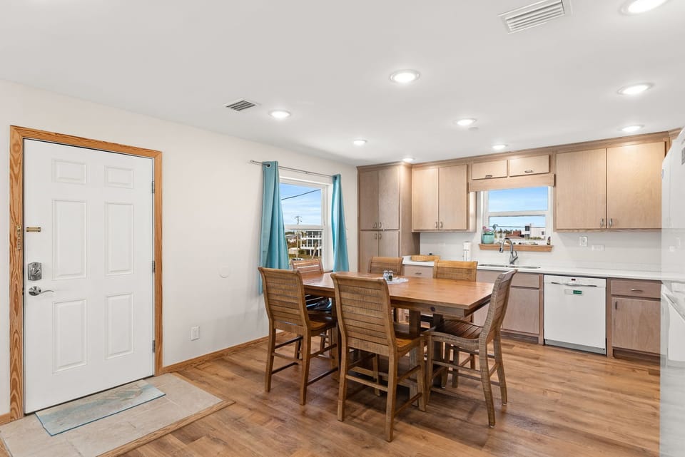 Your open-concept kitchen and dining area features warm wood cabinets, modern appliances, and a welcoming table where you can enjoy meals together.