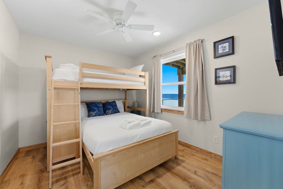 Wake up to breathtaking ocean views from your cozy bedroom, where fresh coastal breezes and the sound of waves greet you each morning through the window.