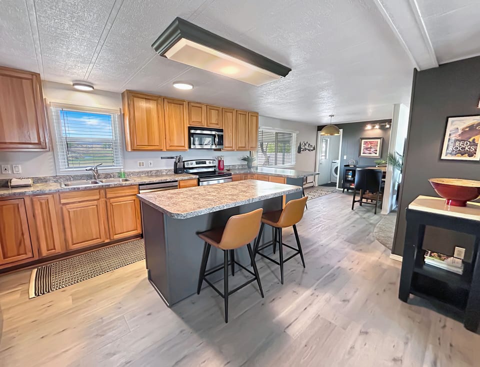 Spacious kitchen with full refrigerator, stove, and dishwasher.