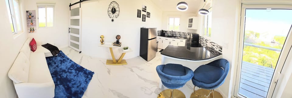 Pano view of the kitchen and living room area. Note the 50" TV is in the MBR.