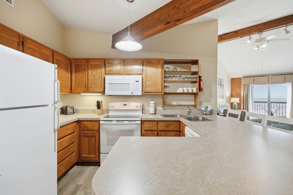 Cook up a family feast in this well-equipped kitchen, featuring ample counter space and gleaming appliances for all your culinary adventures.