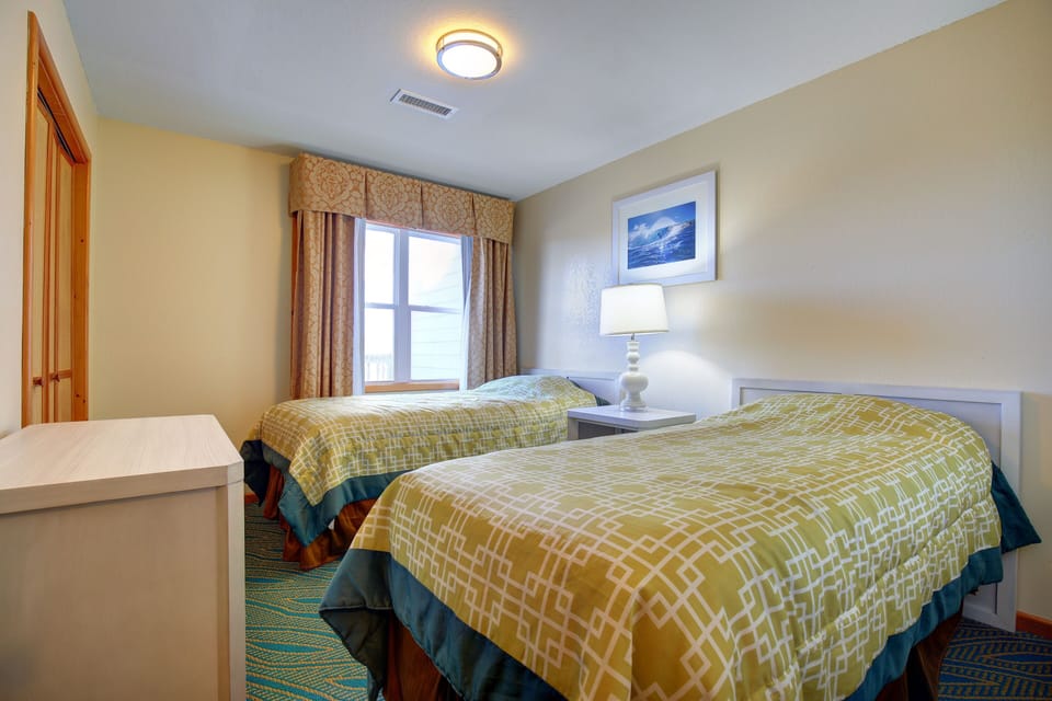 Bright and cheerful, the second bedroom features twin beds and plenty of natural light, perfect for family or guests.