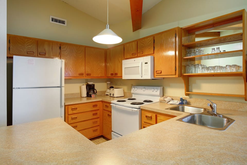 The fully equipped kitchen offers convenient amenities for preparing meals, with ample counter space for all your culinary adventures.