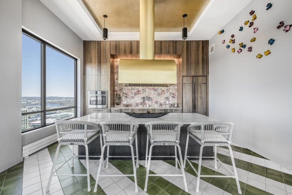 A refined common lounge/demo kitchen with high chair seating and curated design touches. Your go-to place for relaxation outside the apartment.