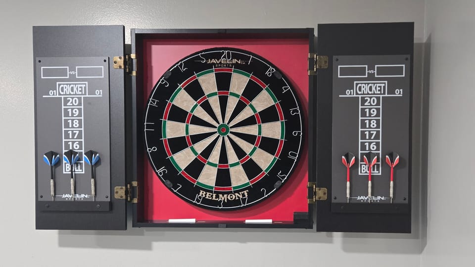 Wall-mounted dartboard set for guest entertainment.