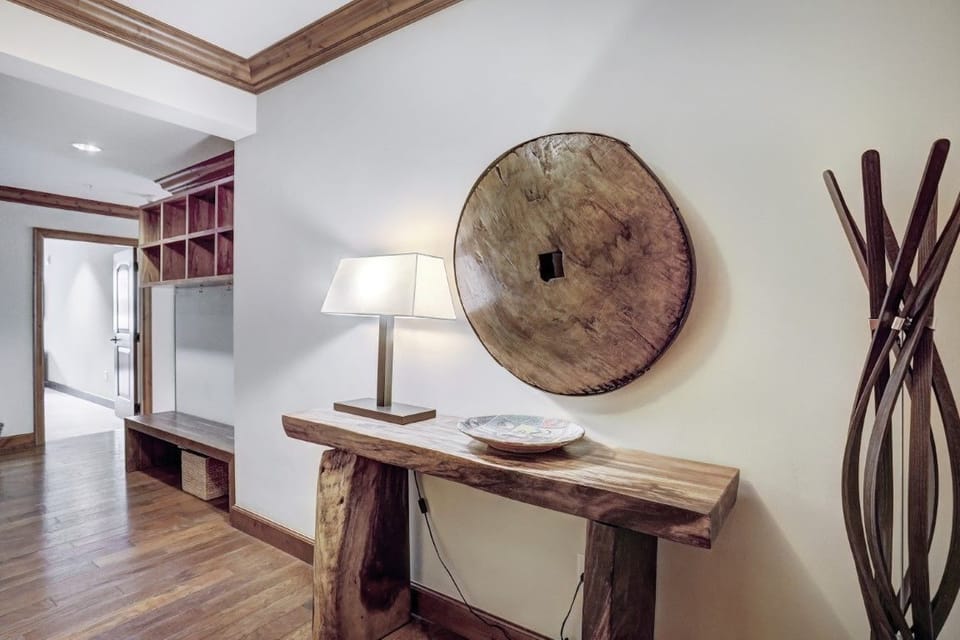 Elegant entryway featuring a rustic wooden console table and tasteful decor, setting the tone for the luxury residence.