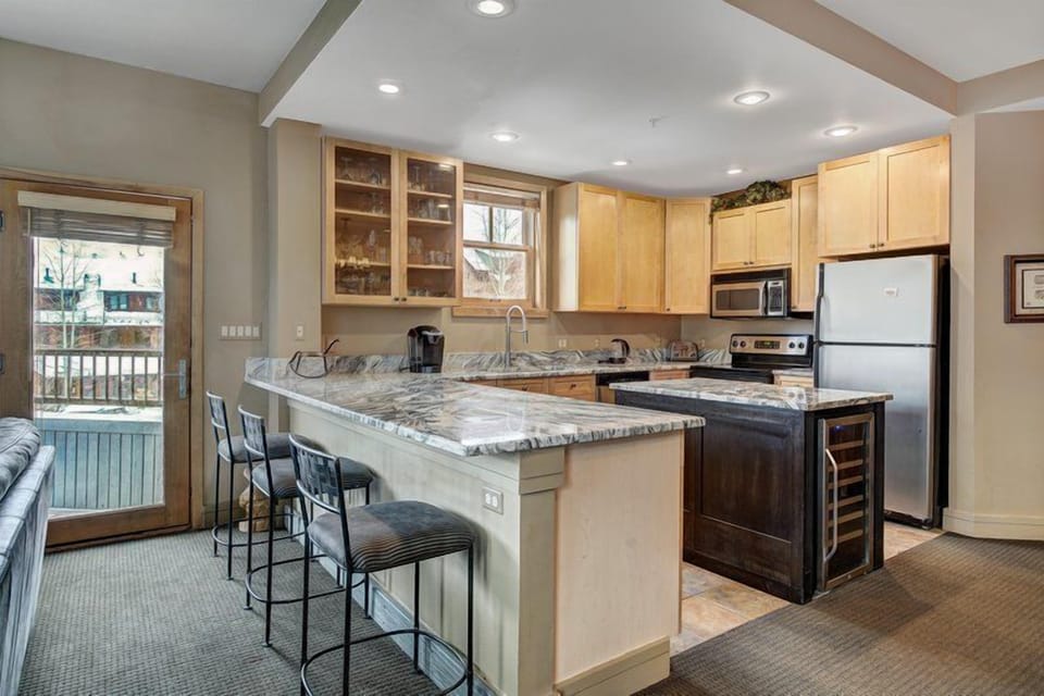 The full kitchen boasts modern appliances and ample counter space, ensuring family meals and gatherings are effortlessly enjoyable.