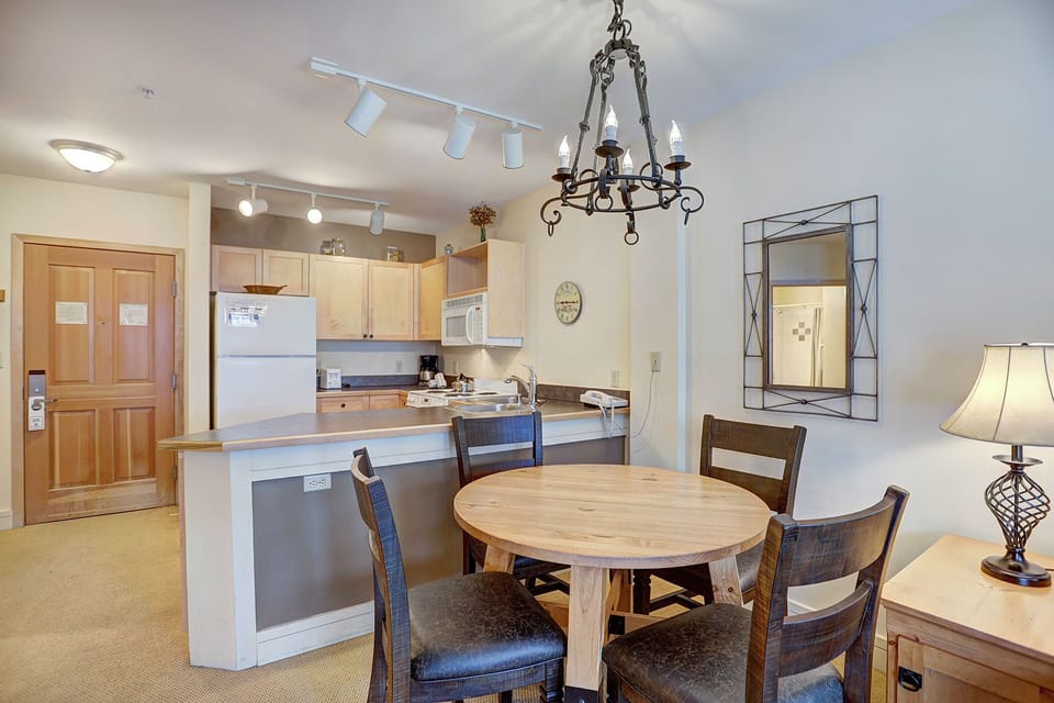 The dining area, decorated with rustic charm, is perfect for enjoying meals after a day of outdoor adventures.