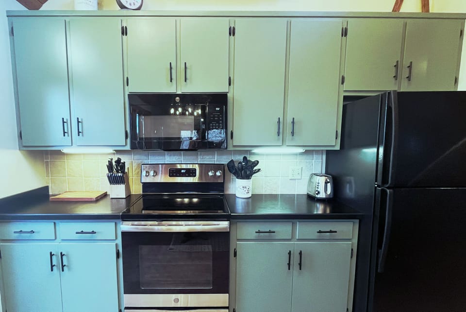 Kitchen 
has Electric Stainless Steel Stove and Oven, Microwave, Dishwasher, Refrigerator, Double Sink, and is stocked with some essentials such as spices and coffee pods