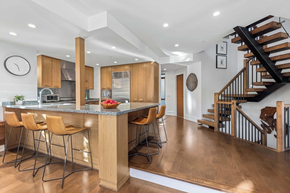 - Modern kitchen with bar seating and plenty of prep space  
- Stainless appliances make cooking simple for families and groups  
- Warm wood cabinetry enhances the inviting mountain home feel  
