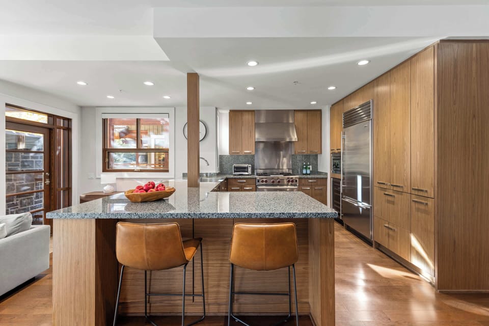 - Large kitchen island perfect for breakfasts and group cooking  
- Natural light fills the space through wide bright windows  
- Modern layout connects kitchen to living areas for easy flow  
