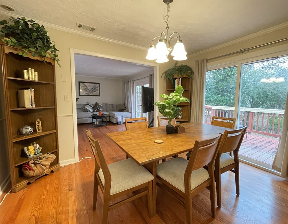 Dining room & living room with view to deck and backyard
