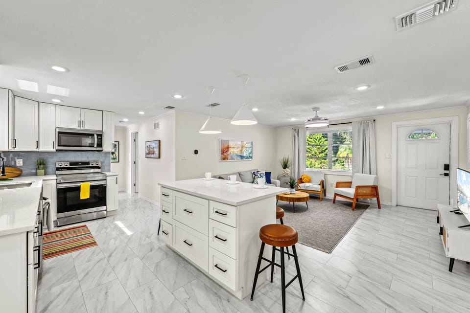 Cook with ease in this open kitchen where bright finishes flow seamlessly into the airy living space.