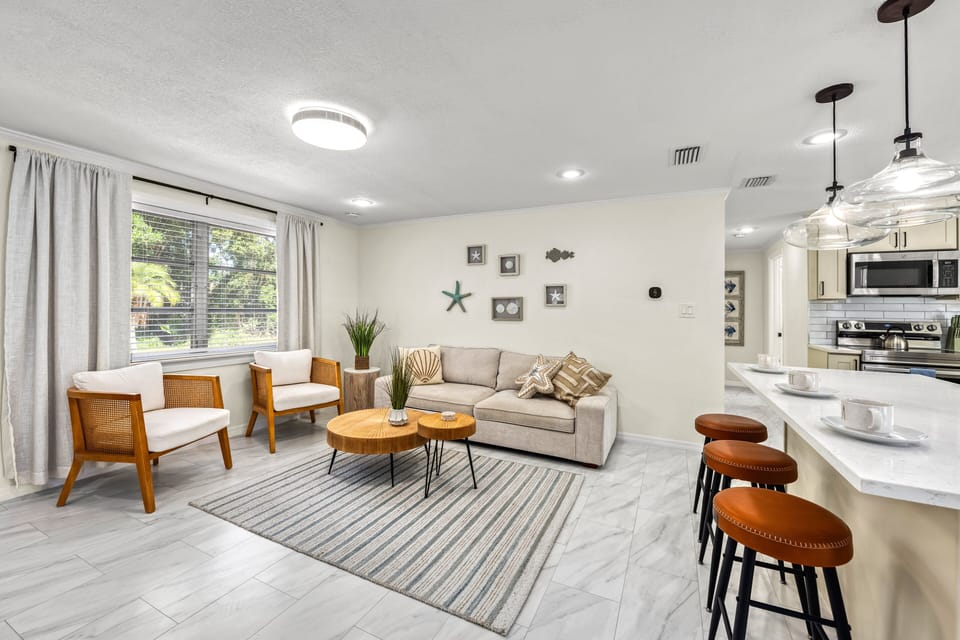 Sink into the plush sofa with a cold drink, where every seating choice encourages a moment of true, island-style rest.