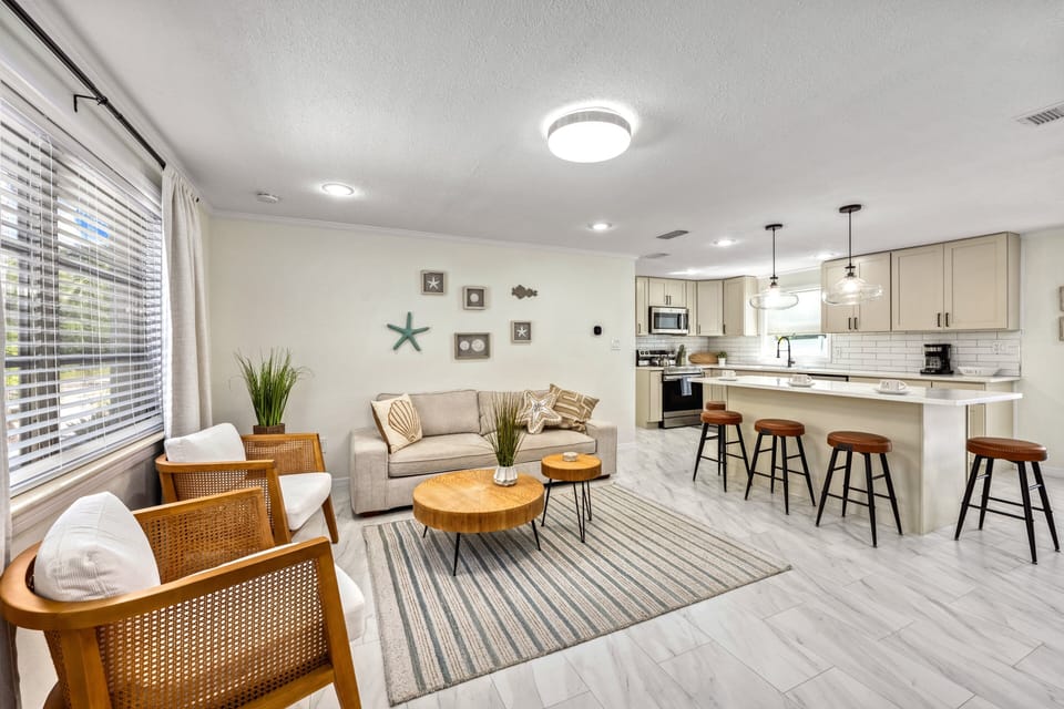 The seamless flow between the sunlit kitchen and comfortable living area ensures you stay connected, whether cooking or relaxing.