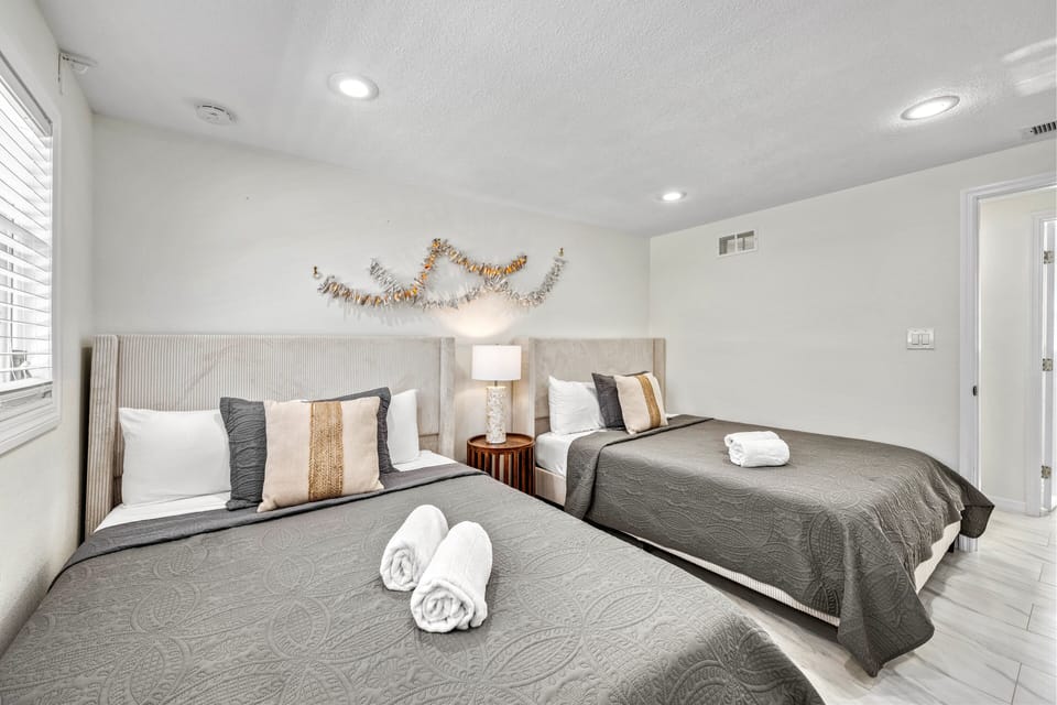 This bright, comfortable bedroom provides the ideal sleeping setup for children or friends with two excellent Queen-sized beds.