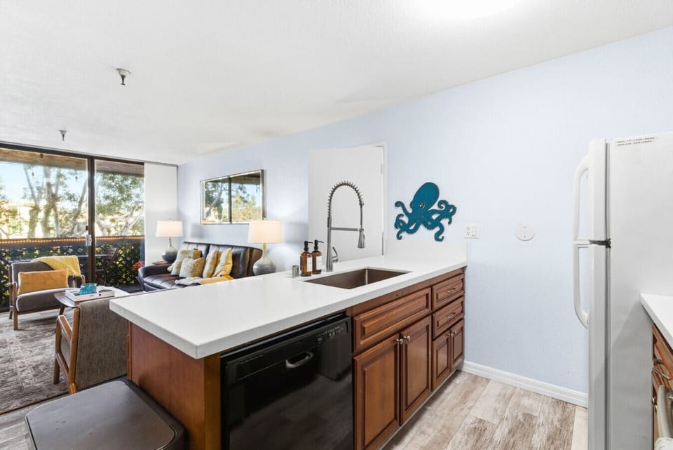 The spacious kitchen opens seamlessly to the living area, creating a bright and welcoming space for cooking, entertaining, and relaxing together.