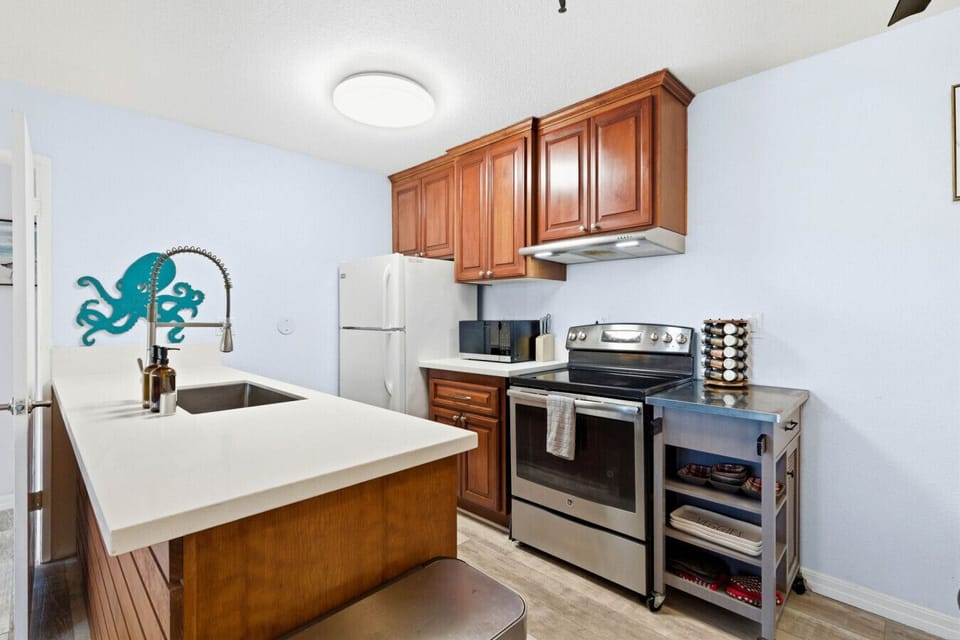 Prepare everything from morning coffee to home-cooked dinners in this well-appointed kitchen featuring modern appliances, ample counter space, and all the essentials for your stay.