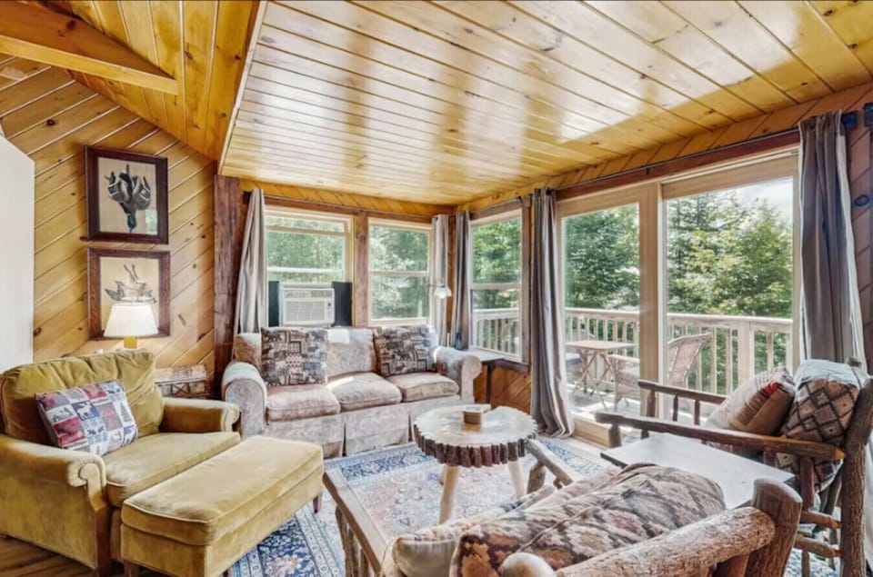 Cozy living room with rustic wood accents and lake views.