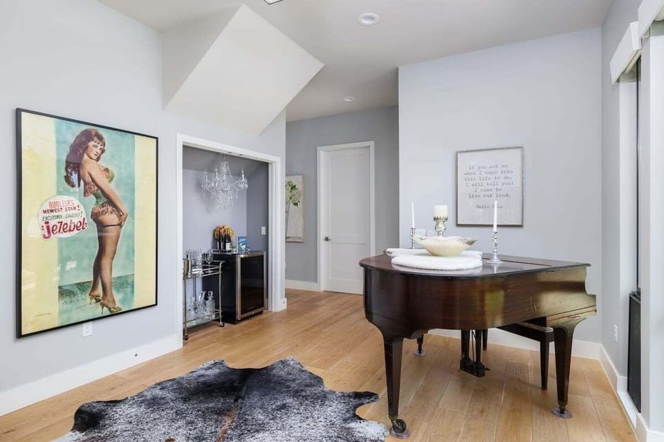 Music Room with a piano, a dry bar, and a wine fridge