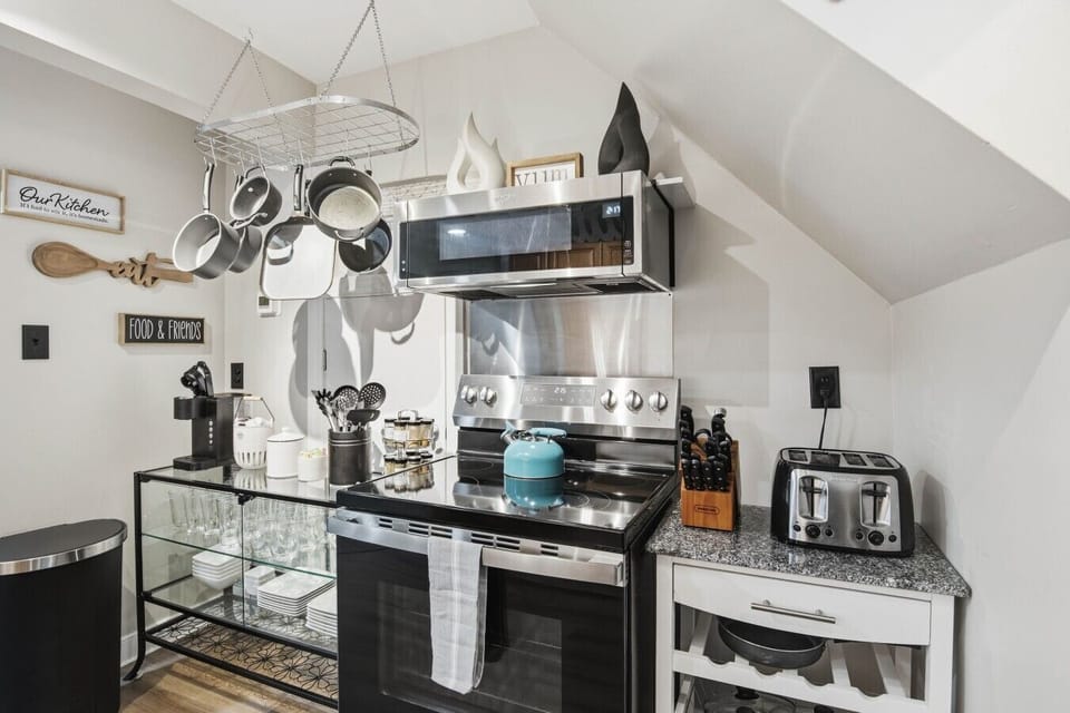 A well‑equipped upstairs kitchen with a compact oven, stove, microwave, Keurig, fridge, freezer, and plenty of cabinet space for all your cooking essentials. Ideal for whipping up breakfast, lunch, or dinner during your stay.