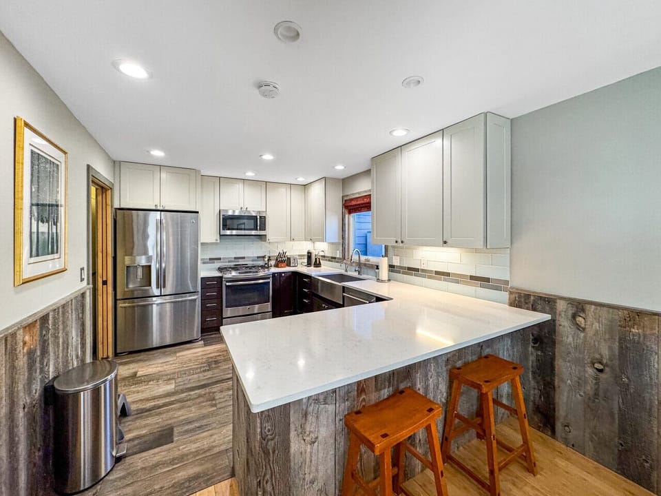 Island seating, ample counters, cabinets stocked with what you need.  Dishes, utensils, basics covered. Kids at the bar doing homework while you cook. Home meals without the full production