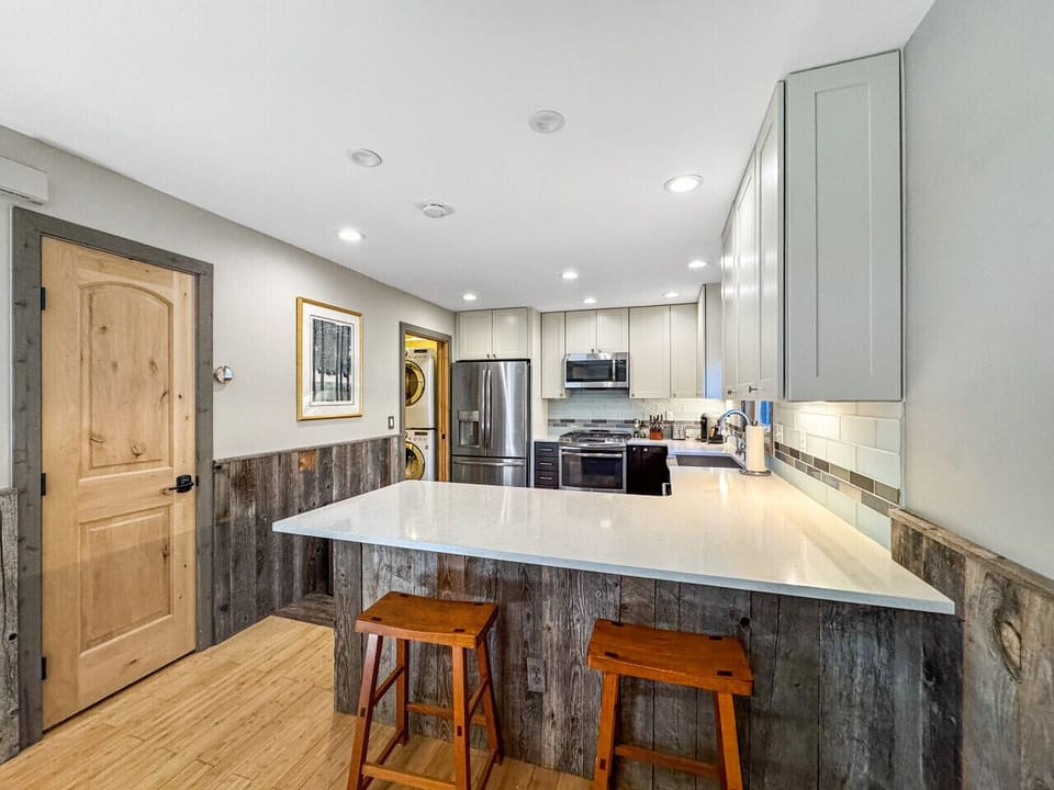 Kitchen flow: pantry access, garage hallway nearby, open movement throughout. Unload groceries without obstacle courses, reach what you need without hunting. Design that thinks about how you actually cook