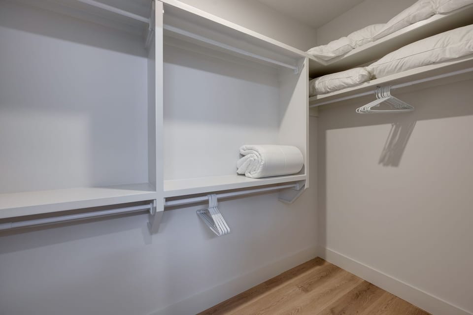 Unit 2: Primary Bathroom (Primary Bedroom en-suite) with dual vanity sinks, large walk-in closet, and stand-in shower.