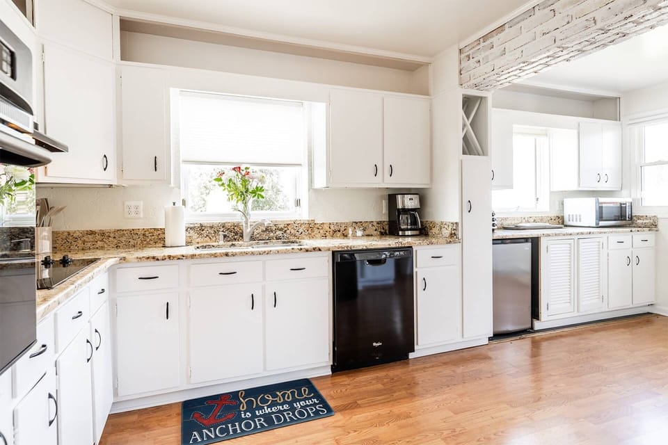 The kitchen's smaller appliances include a beverage fridge, coffeemaker, microwave and toaster.