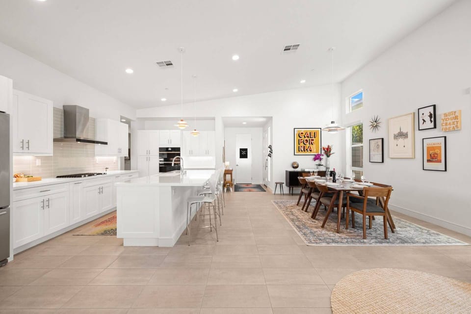 Sleek gourmet kitchen meets artistic dining in this sun-drenched open space.