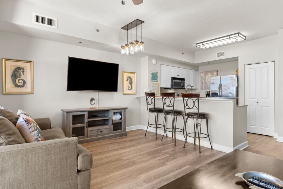 Inviting living space with comfy seating, stylish bar stools, and an easy flow into the kitchen.