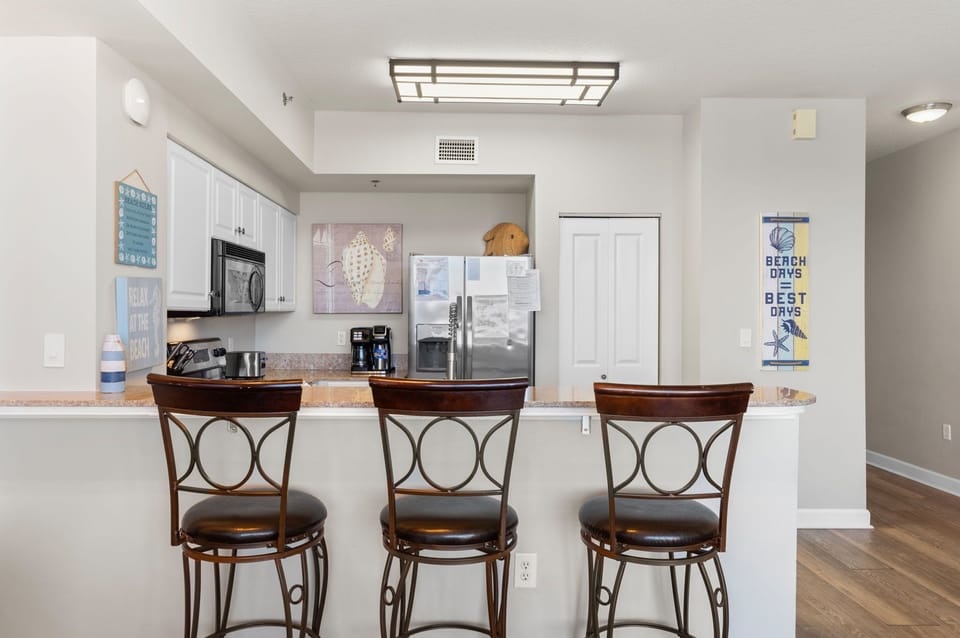 Breakfast bar seating for three makes this kitchen perfect for casual meals and easy conversation.