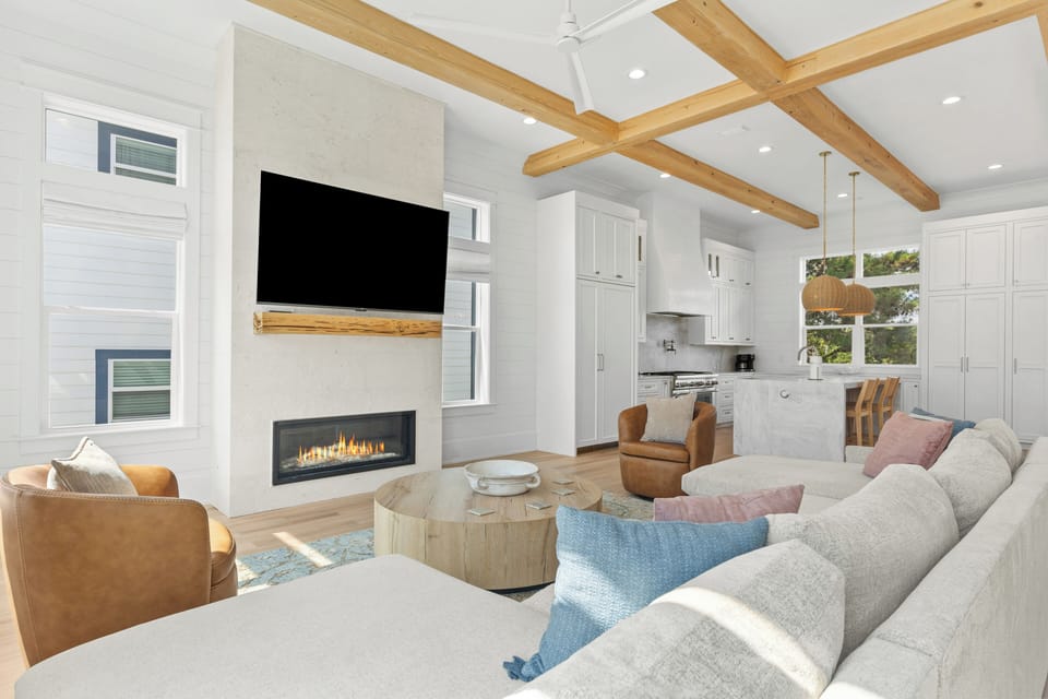 The living room features a couch, fireplace, and TV for endless entertainment.