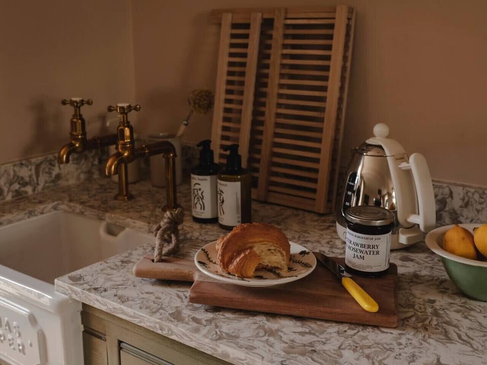 Thoughtfully detailed kitchenette with high-quality fixtures and premium British appliances