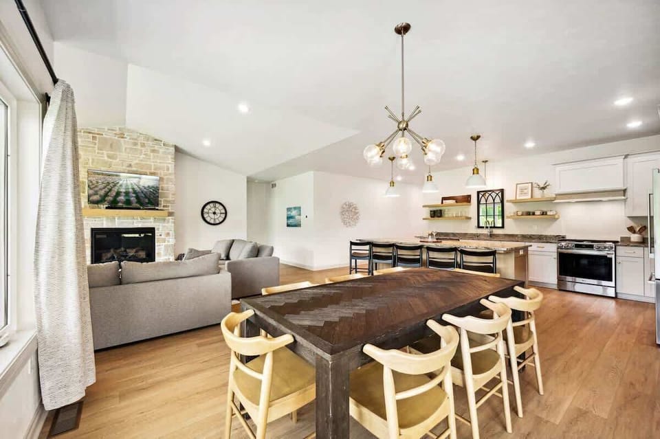 The fully equipped kitchen offers high-end appliances, a large center island, and plenty of room to cook and share stories while dining together at the table for eight.